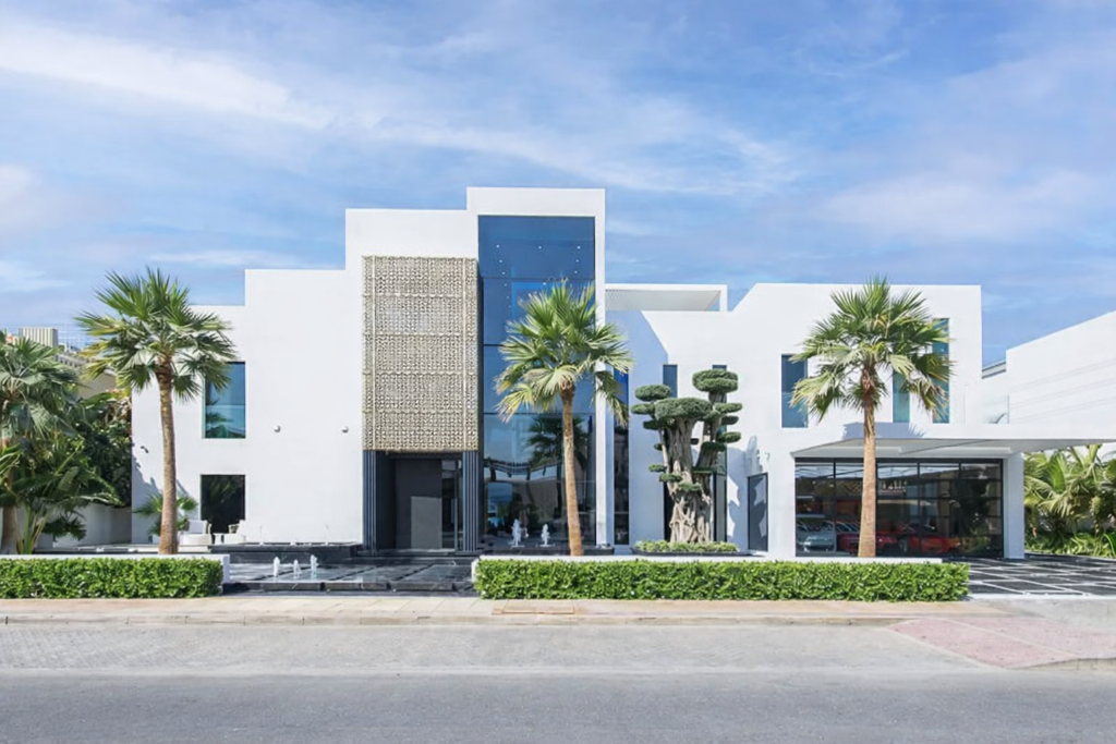White 5 bedroom villa facade with blue glazing and palms on Palm Jumeirah, Dubai