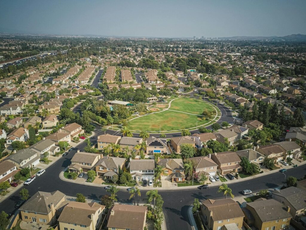 Aerial view of a villa community around a green, lifestyle imagery for Iluka Residences