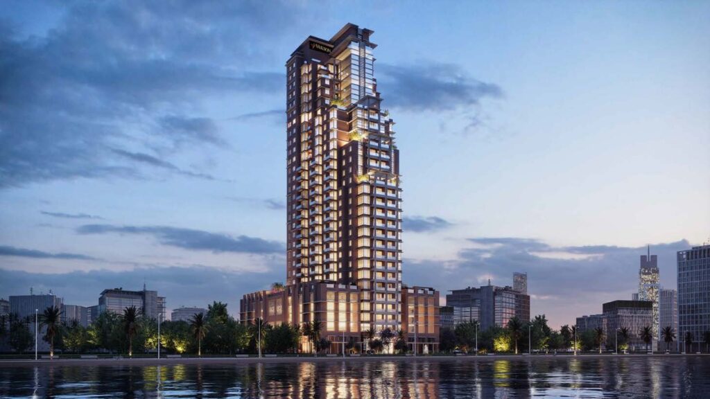 Riva Residence tower lit at dusk on the waterfront, Dubai Maritime City