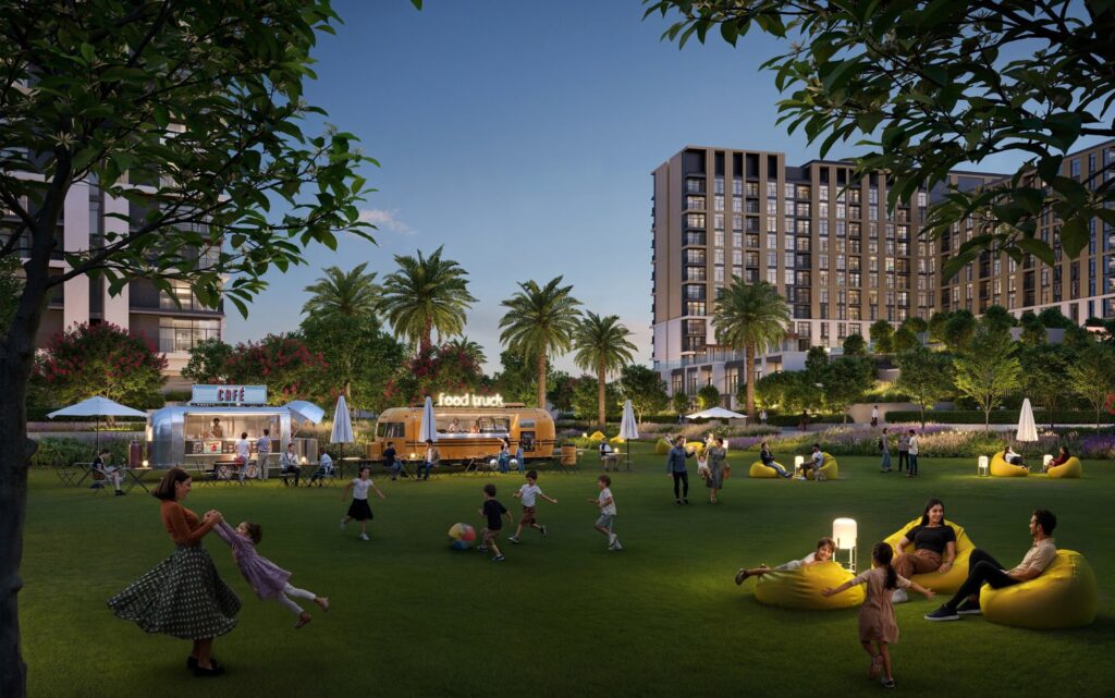 Residents relaxing on the park lawn at Terra Gardens, Dubai South