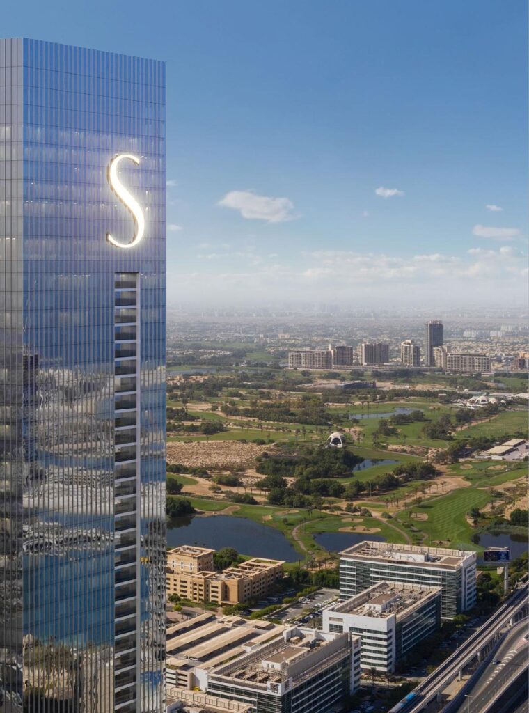 The S Tower by Sobha glass tower with S logo above the city