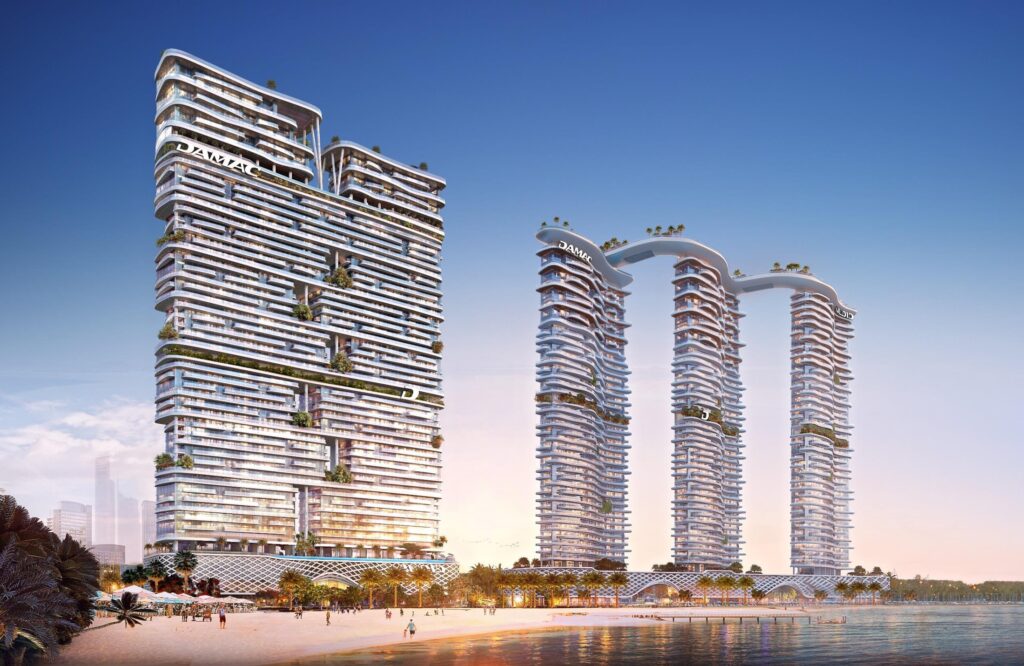 Stepped beachfront tower and linked twin towers on the shoreline at dusk at DAMAC Bay 2, Dubai Harbour
