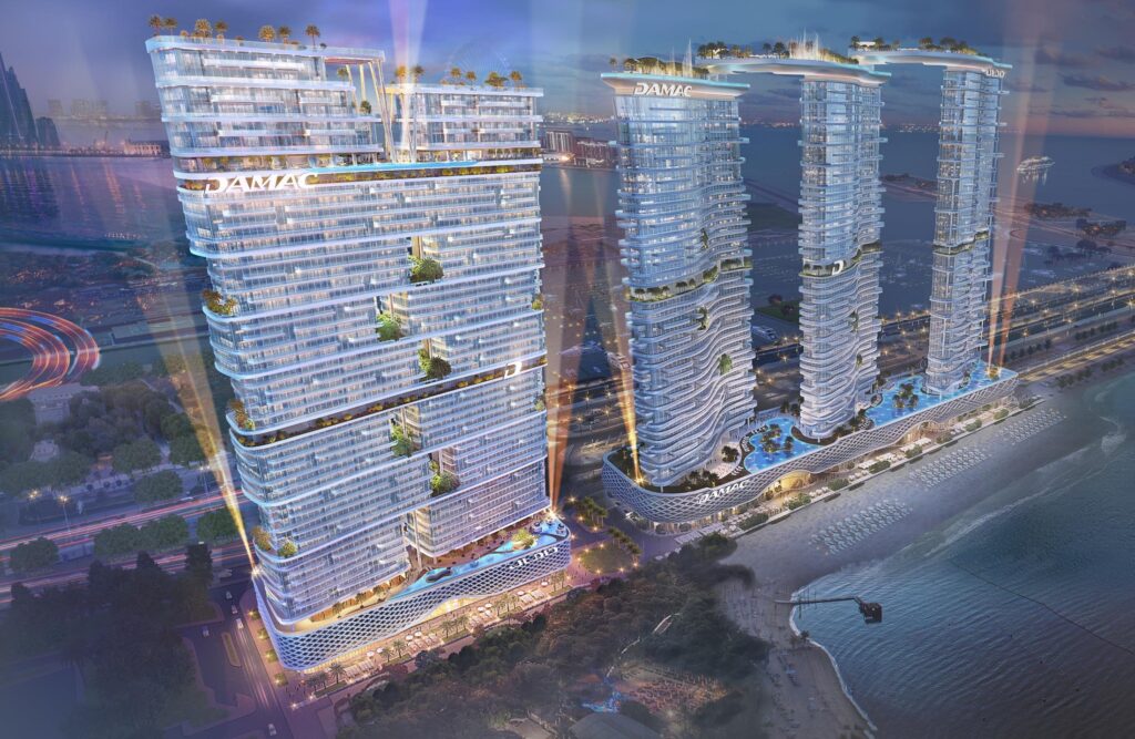 Illuminated towers rising above the waterfront at night at DAMAC Bay 2, Dubai Harbour
