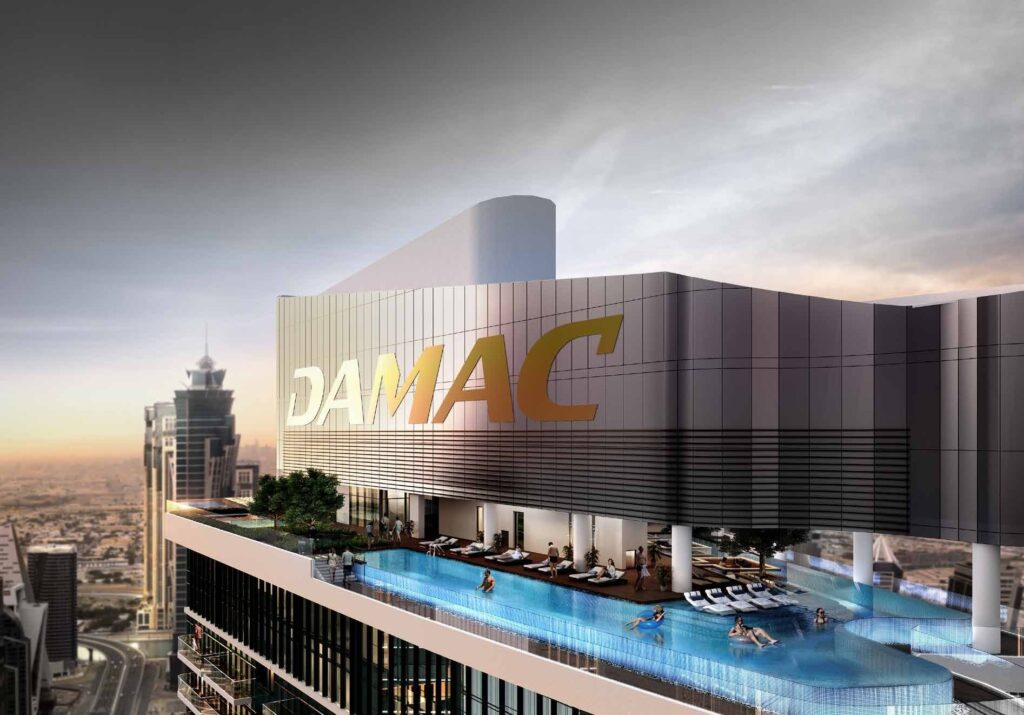 Rooftop pool deck with DAMAC signage at sunset at DAMAC Towers by Paramount, Business Bay