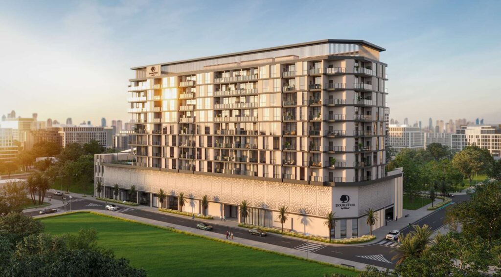 DoubleTree by Hilton Residences building at sunset beside a green lawn, Jumeirah Garden City, Al Wasl
