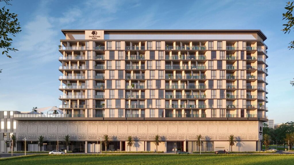 DoubleTree by Hilton Residences building with palm trees and retail podium, Jumeirah Garden City, Al Wasl
