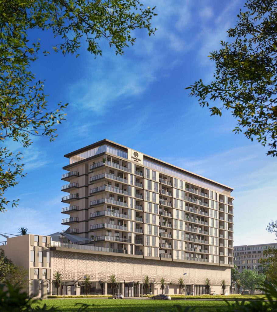 DoubleTree by Hilton Residences building framed by trees under blue sky, Jumeirah Garden City, Al Wasl