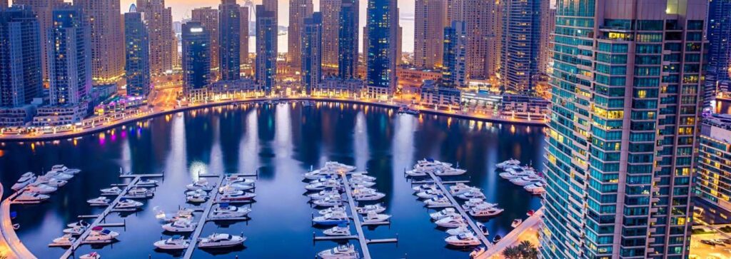 Dubai Marina yachts and towers at dusk near Habtoor Grand Residences