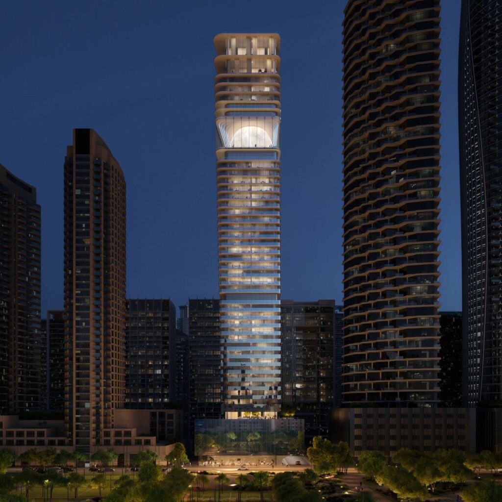 Inaura Hotels and Residences tower lit up among the Downtown towers at night