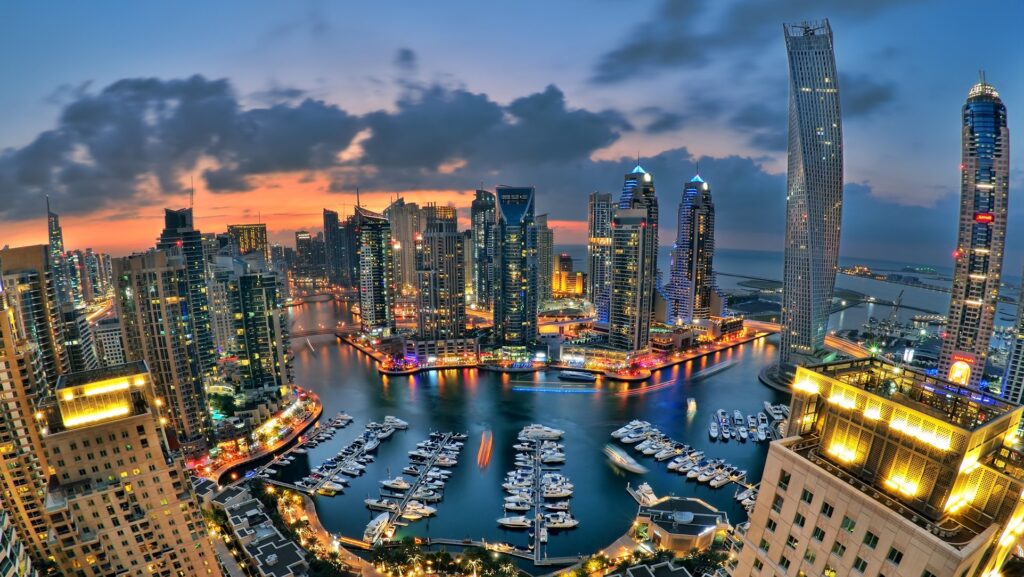 Aerial view of the marina skyline at dusk with yachts moored, setting of Marina Shores, Dubai Marina