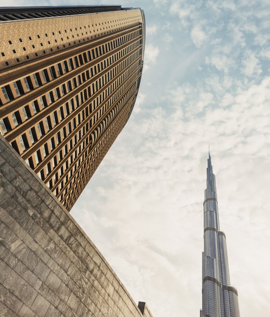 Ocean Star tower facade seen from below with the Burj Khalifa in the distance