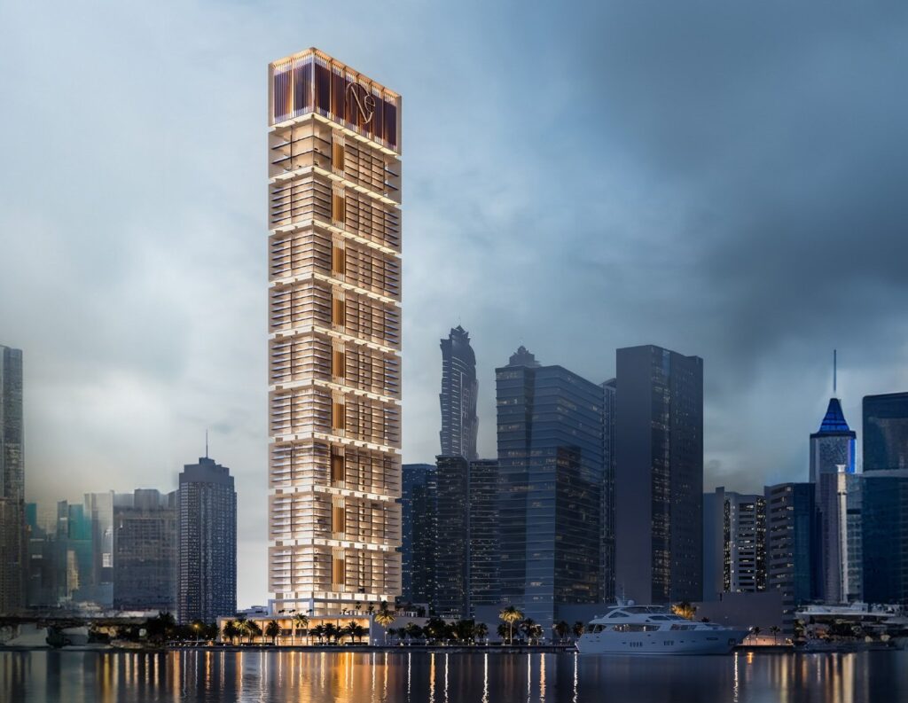 One by Binghatti tower lit at dusk above the canal, Business Bay