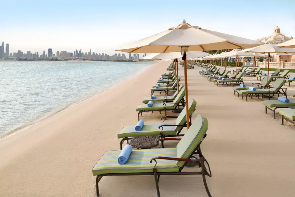 Beach loungers and parasols facing the sea at Raffles Residences The Palm, Palm Jumeirah