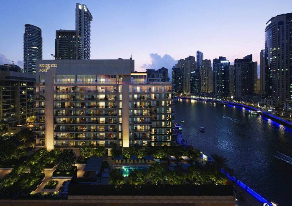 Residences Du Port lit at dusk beside the marina canal, Dubai Marina