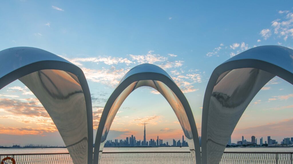 Sculptural arches framing the Dubai skyline near Rove Home Dubai Marina