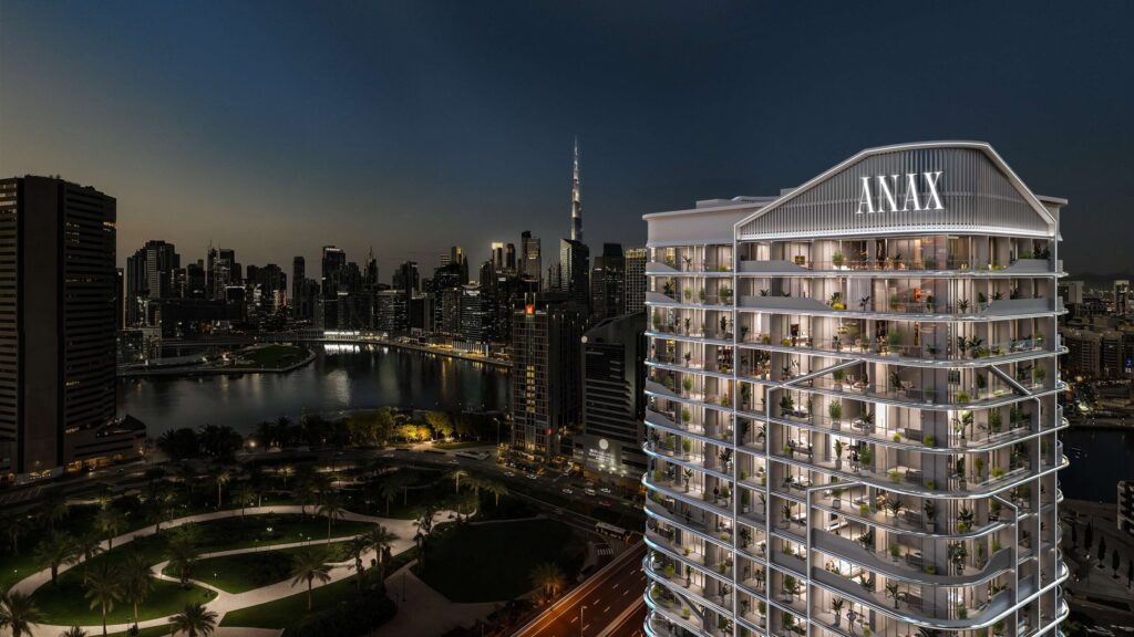 V Suites by ANAX tower lit at night beside the Dubai skyline, Business Bay