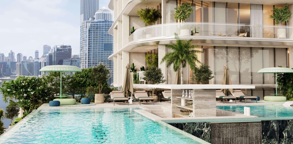 Podium swimming pool with palms and city towers at V Suites by ANAX, Business Bay