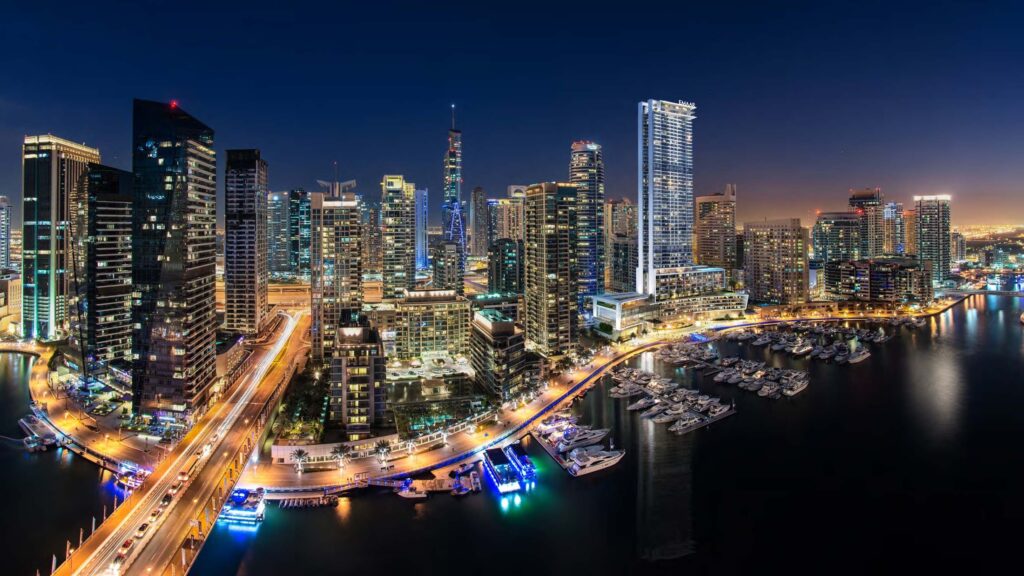 Dubai Marina lit at night around Vida Dubai Marina