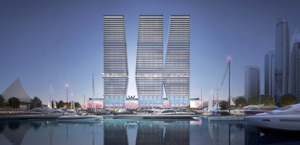 W Residences Dubai Harbour towers reflected in the marina at dusk